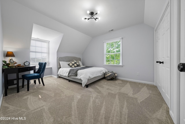 carpeted bedroom featuring multiple windows and vaulted ceiling