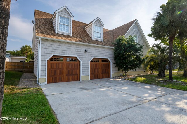 view of property exterior featuring a lawn and a garage