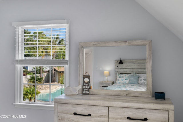 bedroom with multiple windows and vaulted ceiling