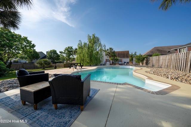 view of swimming pool with a patio