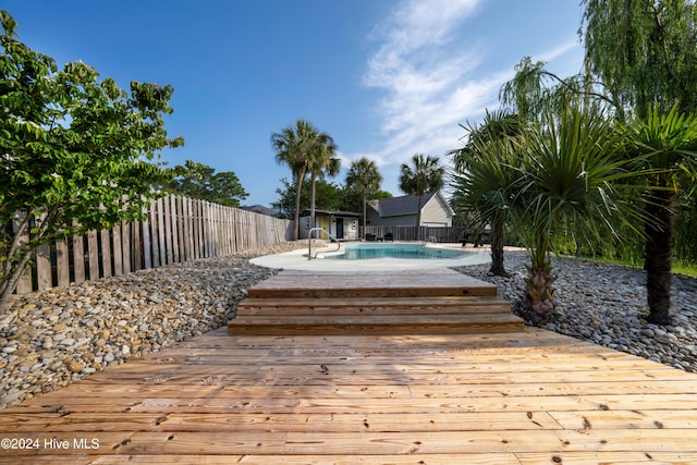 deck with a fenced in pool