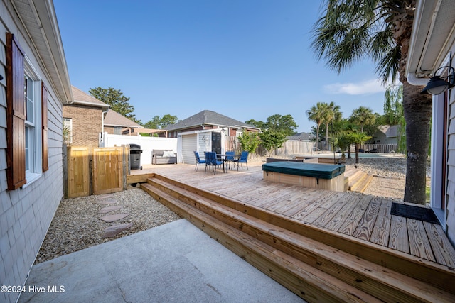 wooden deck with an outbuilding and a covered hot tub