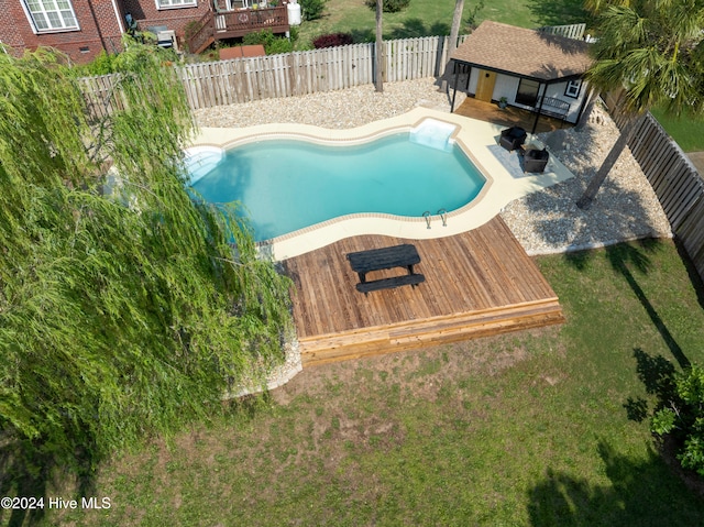 view of swimming pool with a patio and a deck