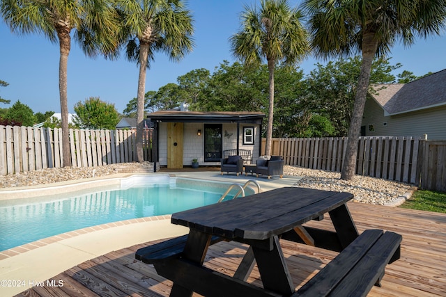 view of pool featuring an outdoor structure and a deck