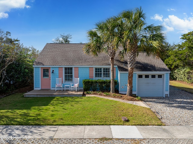 view of front of house with a garage and a front yard