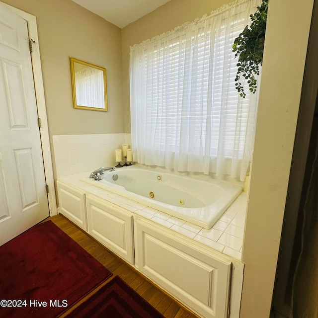 bathroom with hardwood / wood-style floors and a bathtub