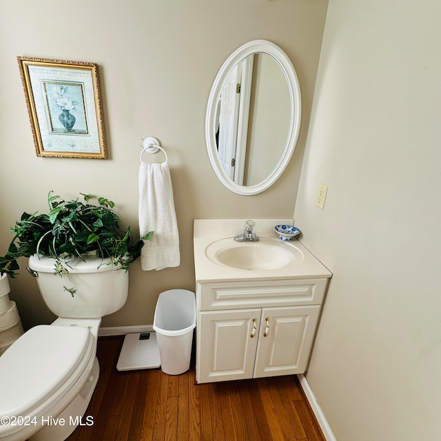 bathroom with vanity, hardwood / wood-style floors, and toilet