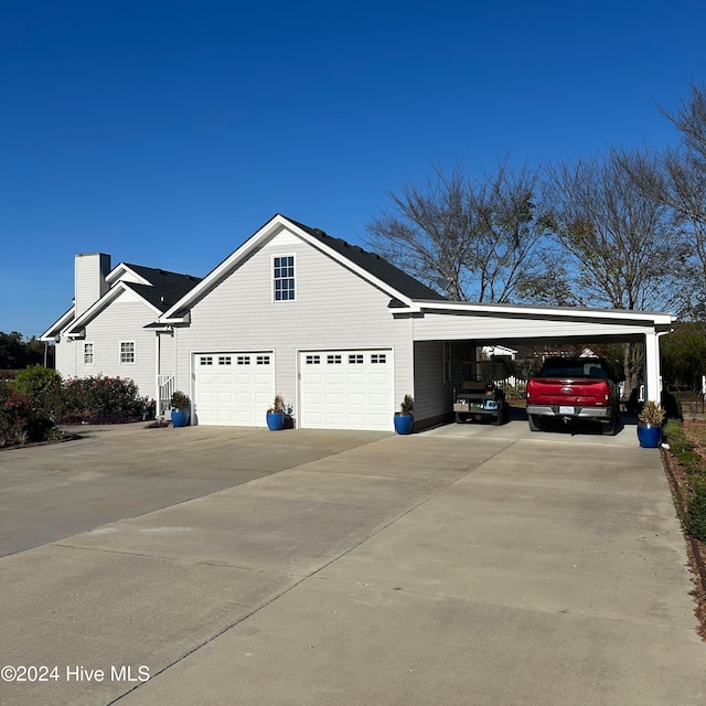 view of side of home featuring a carport and a garage