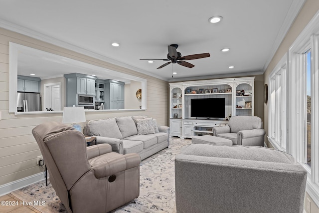 living area featuring wood walls, a ceiling fan, crown molding, and recessed lighting