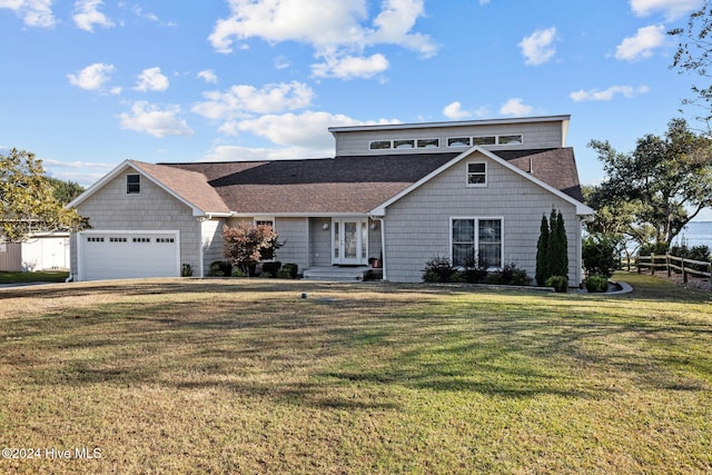 view of front of property with a front yard and a garage