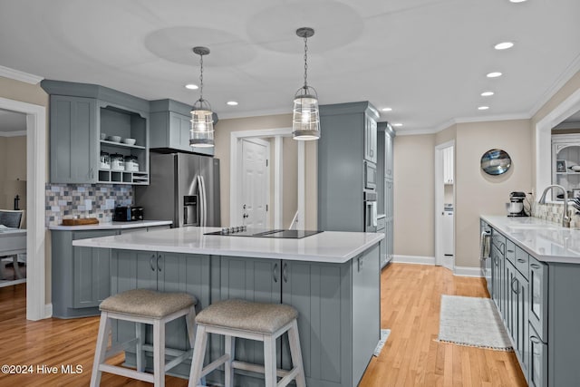 kitchen featuring open shelves, stainless steel appliances, gray cabinets, and a sink