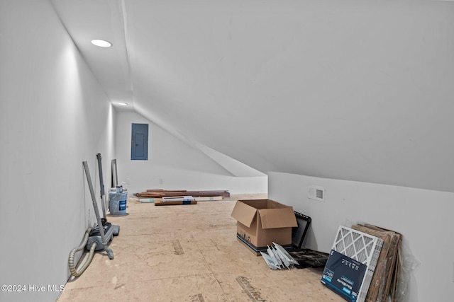 bonus room with lofted ceiling, electric panel, and visible vents