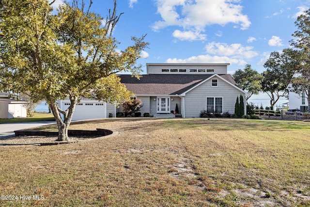 view of front of property with a front lawn and a garage