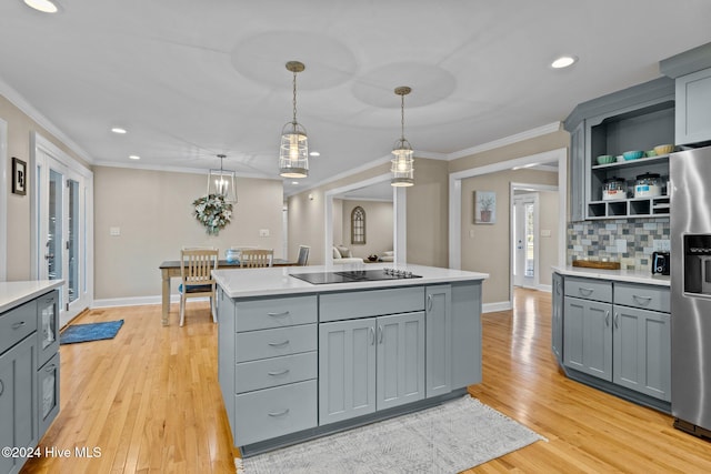 kitchen featuring gray cabinetry, stainless steel refrigerator with ice dispenser, decorative light fixtures, and light hardwood / wood-style floors