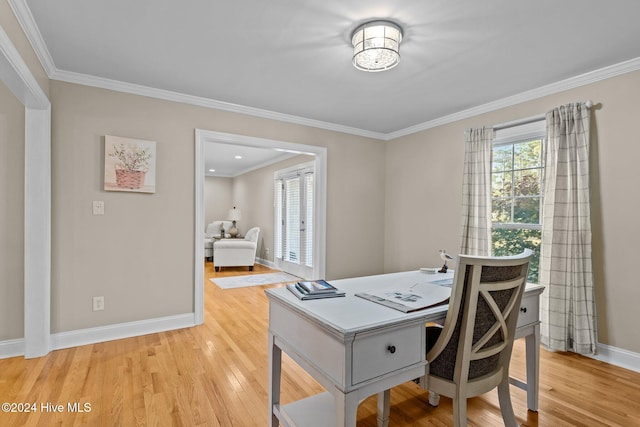 home office with crown molding and light hardwood / wood-style flooring