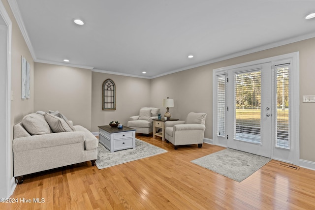 living room featuring light hardwood / wood-style floors and ornamental molding