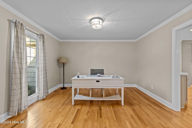 office area featuring crown molding, light wood-type flooring, and baseboards