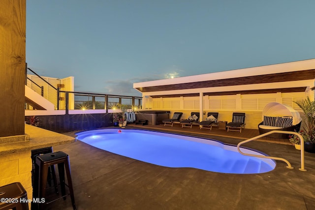 view of pool featuring a patio and a hot tub