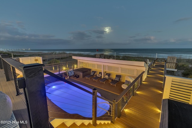 view of swimming pool featuring a fire pit and a water view