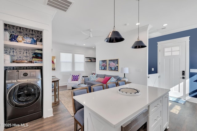 kitchen with dark wood finished floors, visible vents, white cabinets, and washer / clothes dryer