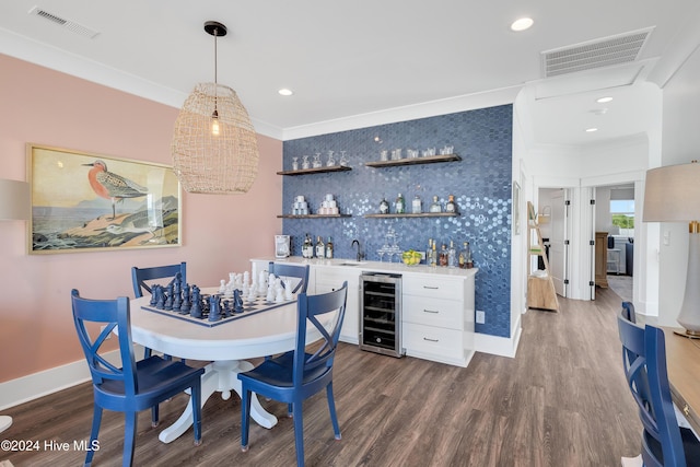 dining area with beverage cooler, visible vents, indoor wet bar, and dark wood-style flooring