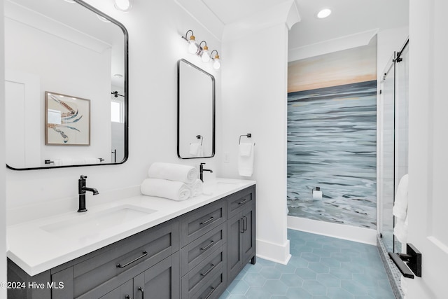 bathroom with a sink, a shower stall, tile patterned floors, and double vanity