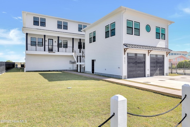 view of front of home with a garage, stairway, a front yard, and fence