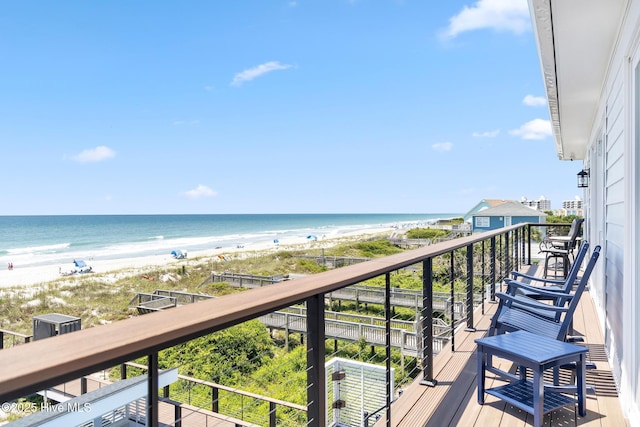 balcony with a view of the beach and a water view