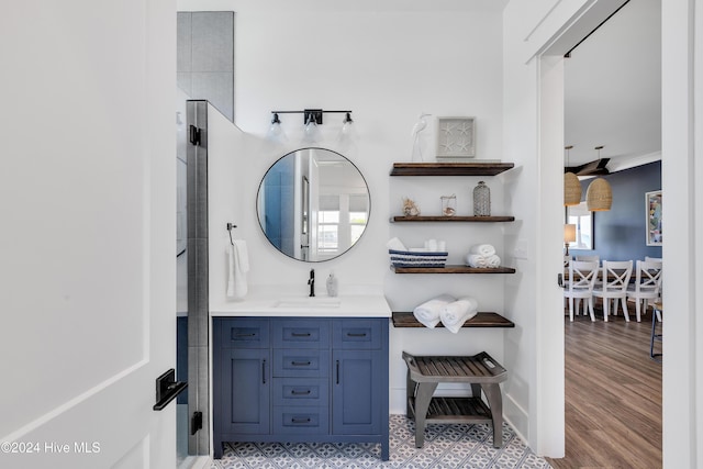 bathroom featuring baseboards, wood finished floors, and vanity