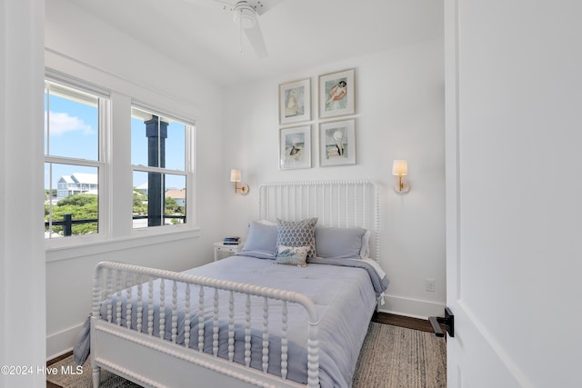 bedroom with baseboards and wood finished floors