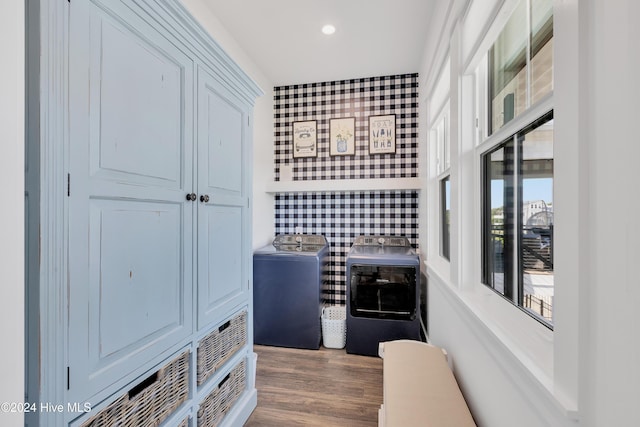 interior space with wallpapered walls, washer and dryer, wood finished floors, and recessed lighting