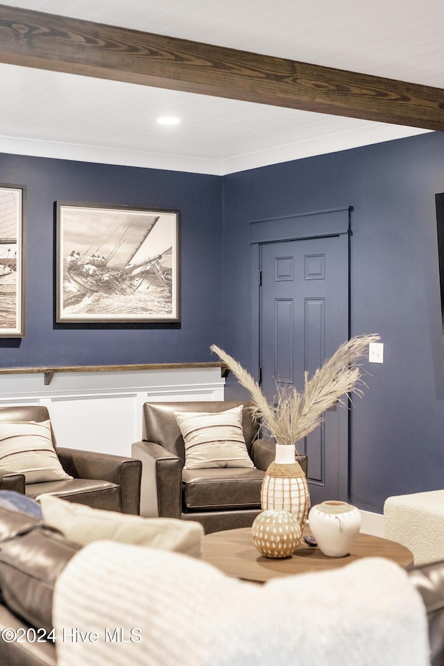 living room with beamed ceiling and ornamental molding