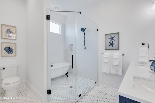 full bathroom featuring toilet, a stall shower, a sink, double vanity, and baseboards