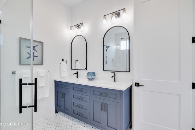 bathroom featuring a sink, a shower, and double vanity