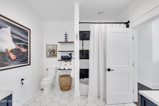 full bathroom featuring vanity, tile patterned floors, toilet, and baseboards