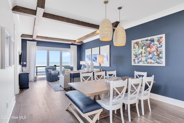 dining space with beamed ceiling, baseboards, and wood finished floors