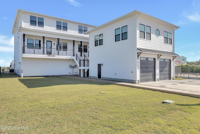 view of front of house featuring stairway, covered porch, concrete driveway, a front yard, and a garage