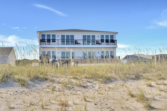 back of house featuring a balcony