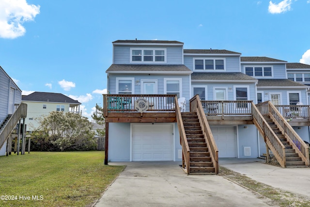 rear view of house featuring a garage, a porch, and a lawn