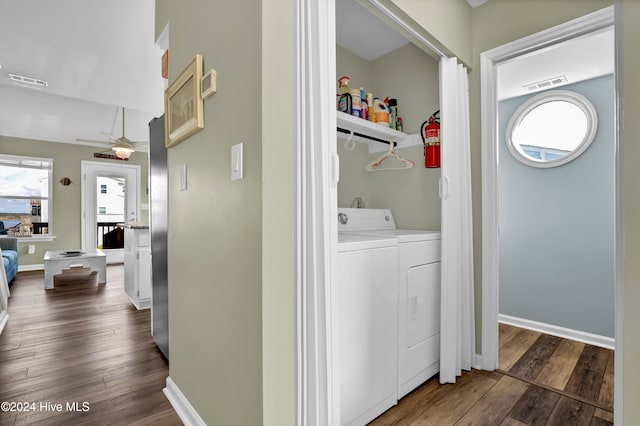 laundry room with dark hardwood / wood-style floors and washing machine and clothes dryer