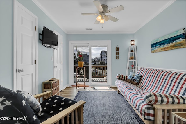 living room with crown molding, hardwood / wood-style floors, and ceiling fan