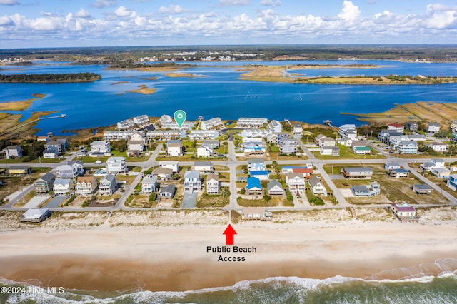 bird's eye view featuring a water view and a beach view