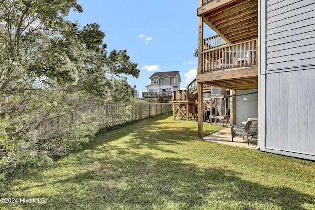 view of yard with a wooden deck and a patio area