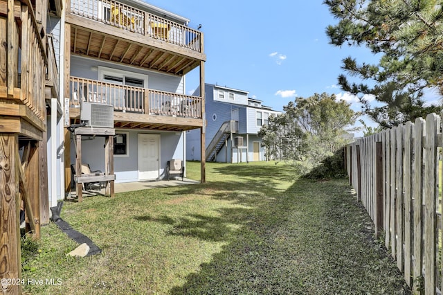 view of yard featuring a wooden deck and central air condition unit