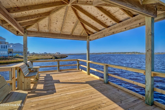 view of dock with a gazebo and a water view