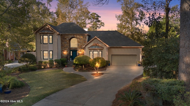 view of front of home with a lawn and a garage