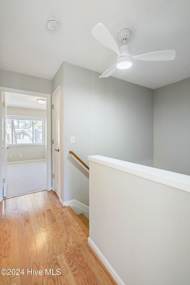 corridor with light hardwood / wood-style flooring