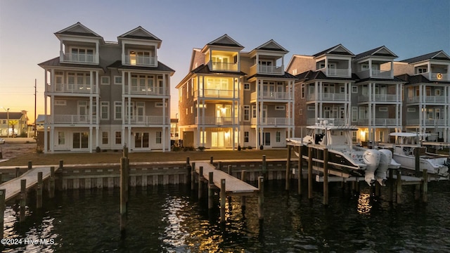 back house at dusk featuring a water view