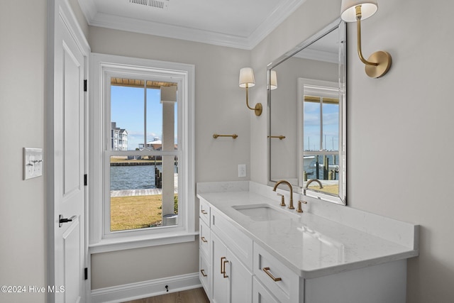 bathroom featuring vanity, a water view, and a healthy amount of sunlight