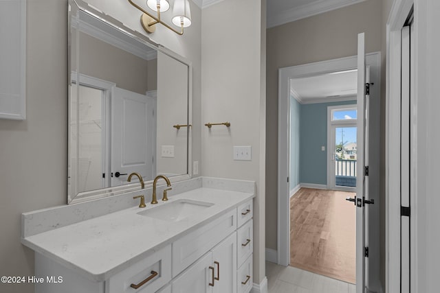 bathroom with hardwood / wood-style floors, vanity, and ornamental molding